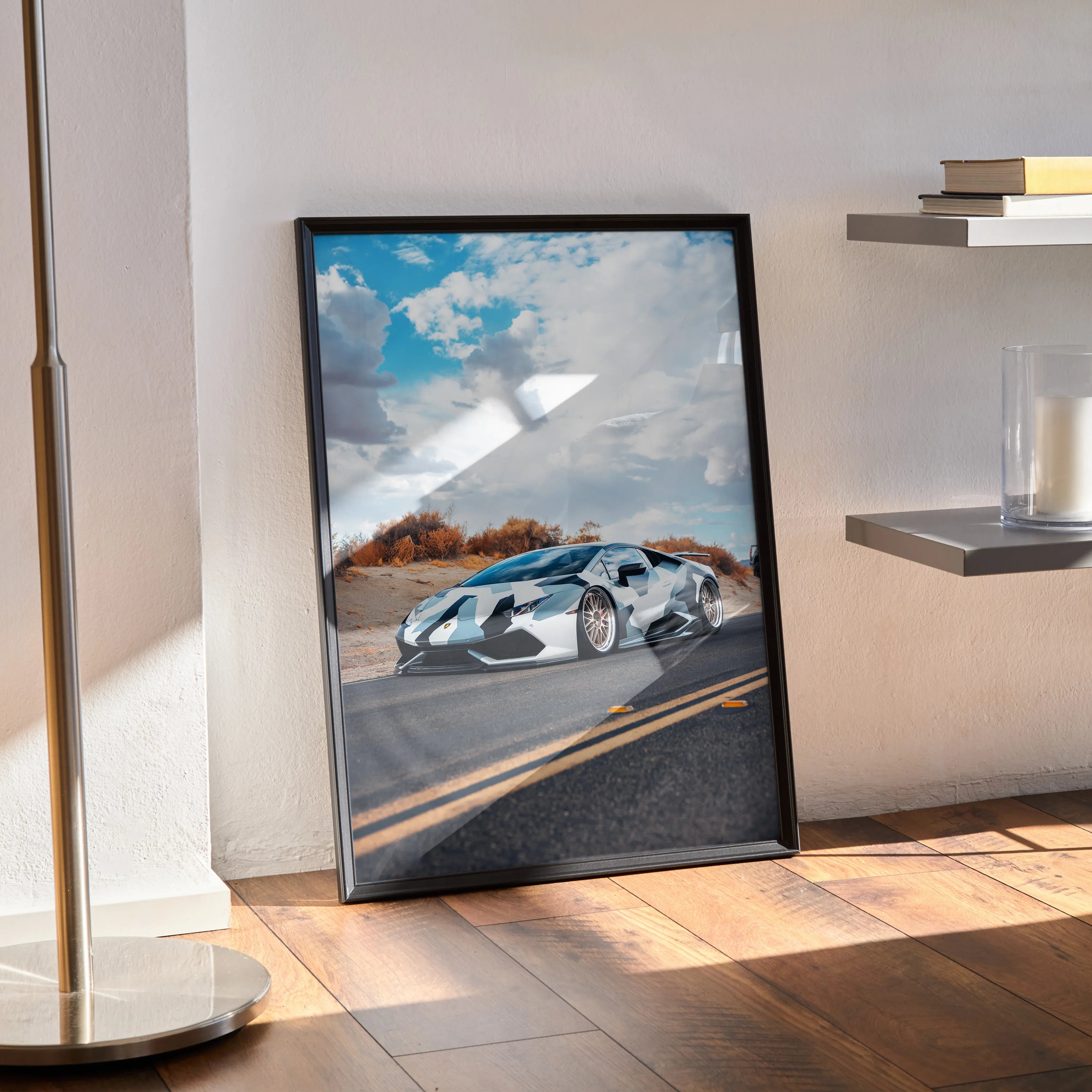 Lamborghini Huracan high resolution poster with blue sky and desert road wall art in black frame displayed on hardwood floor.