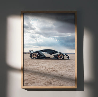 Lamborghini Huracan poster wall art with black and white sports car under dramatic cloudy sky.
