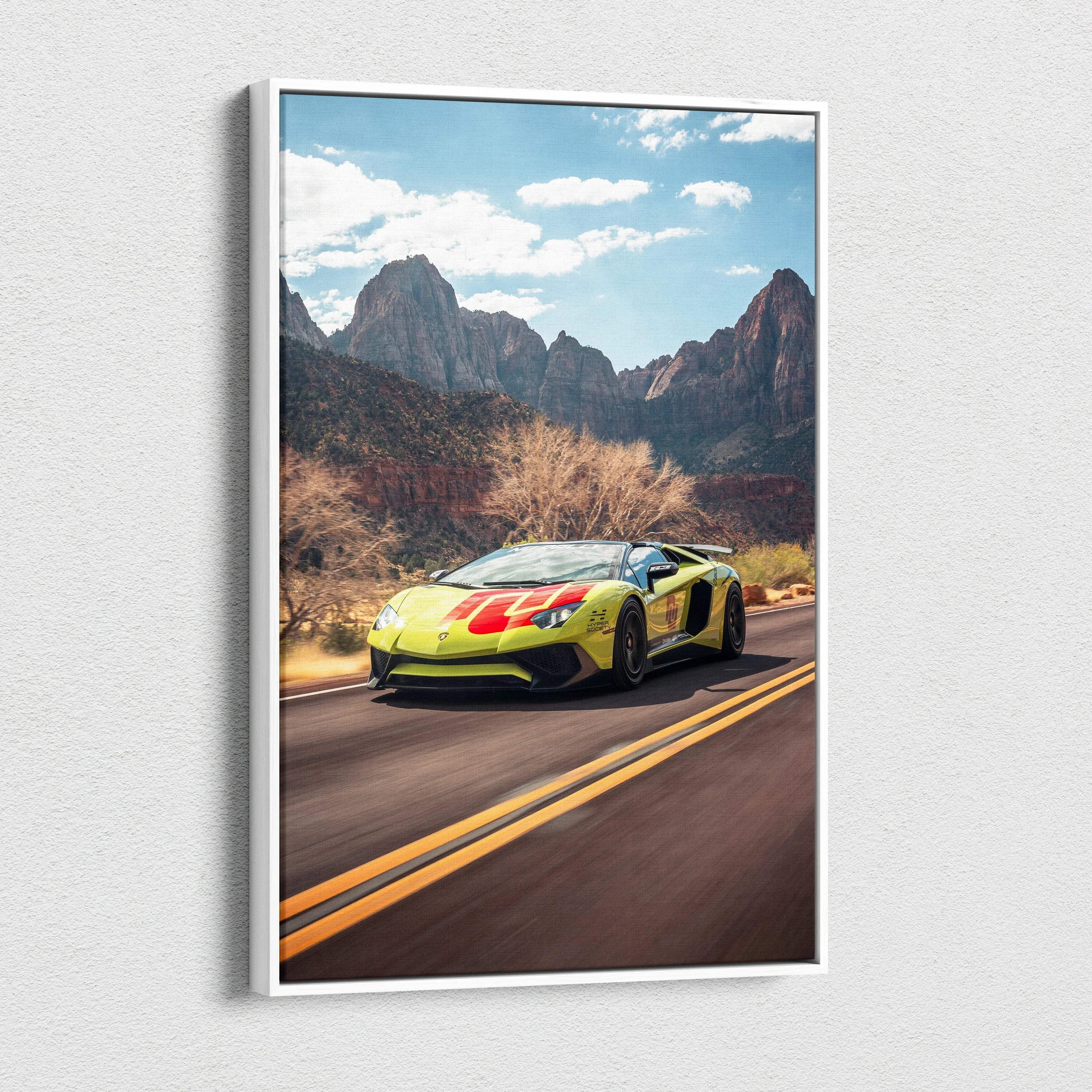 Vertical canvas art of yellow Lamborghini Aventador SVJ on mountain road with blue sky wall art.