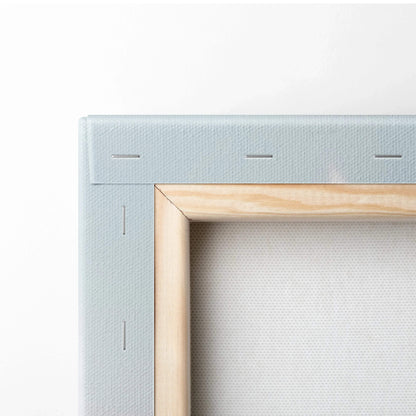 Close-up of stretched canvas wall art corner showing wooden frame and stapled fabric backing.