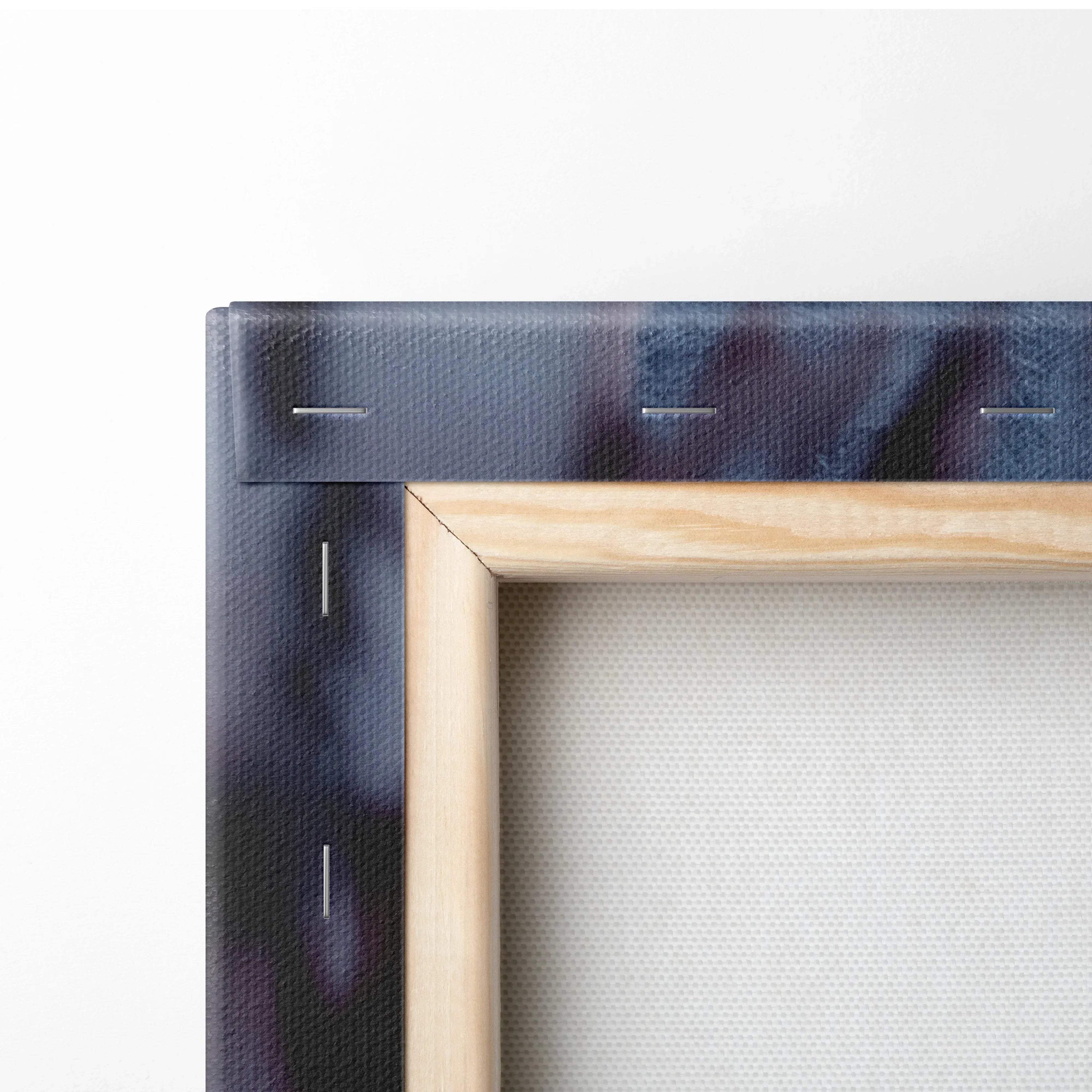 Close-up of canvas wall art corner with wooden frame and dark snowy mountain town print.