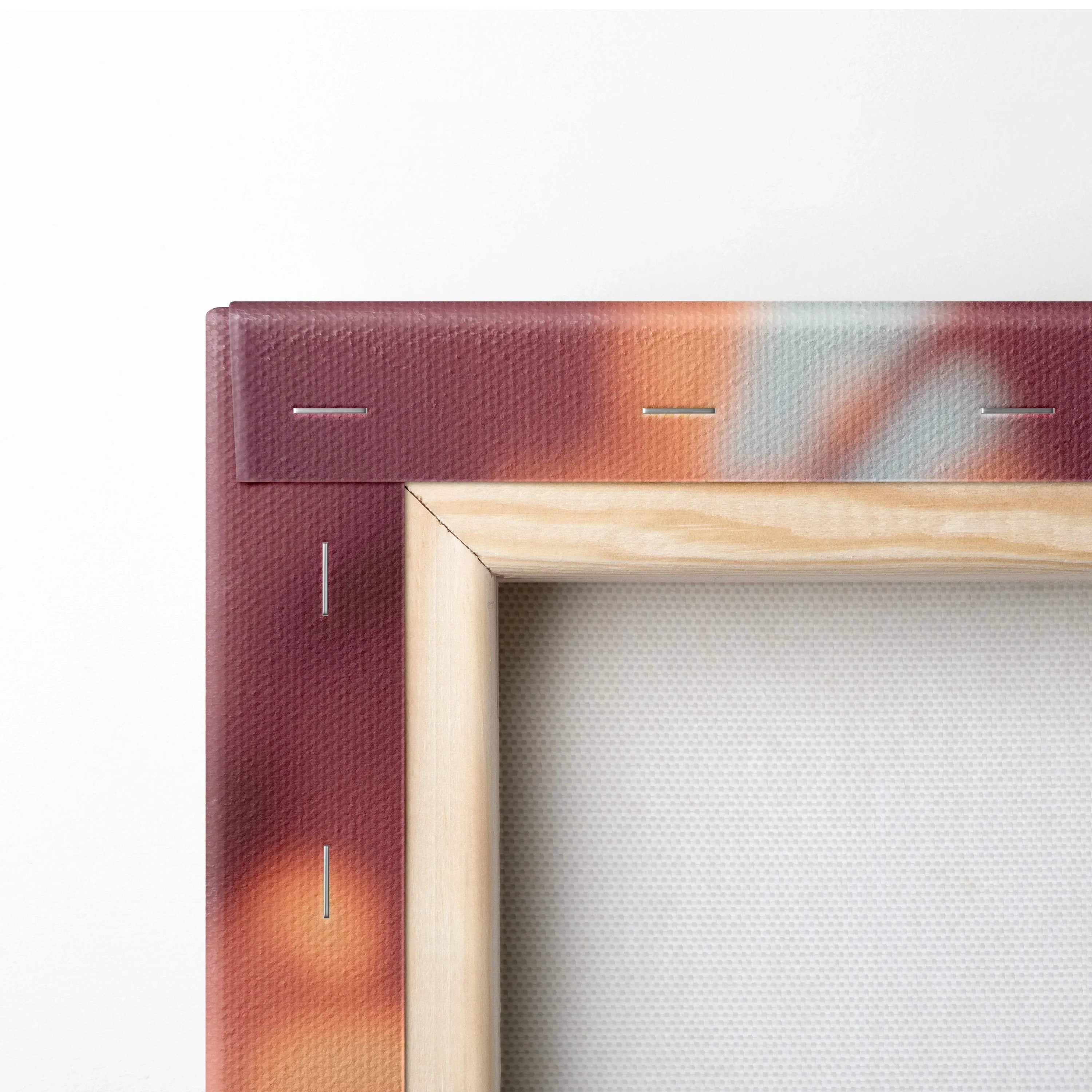 Close-up of canvas edge with wooden frame and staple details on maroon and orange printed fabric wall art.