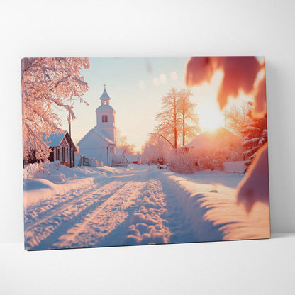 Canvas wall art featuring a snowy winter sunset scene with a quaint white church and frosted trees in soft warm light.