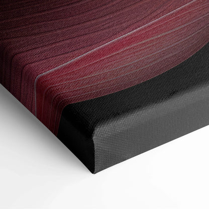 Close-up of wrapped canvas corner showing textured fabric with pink and red cherry blossom floral design on black edges.