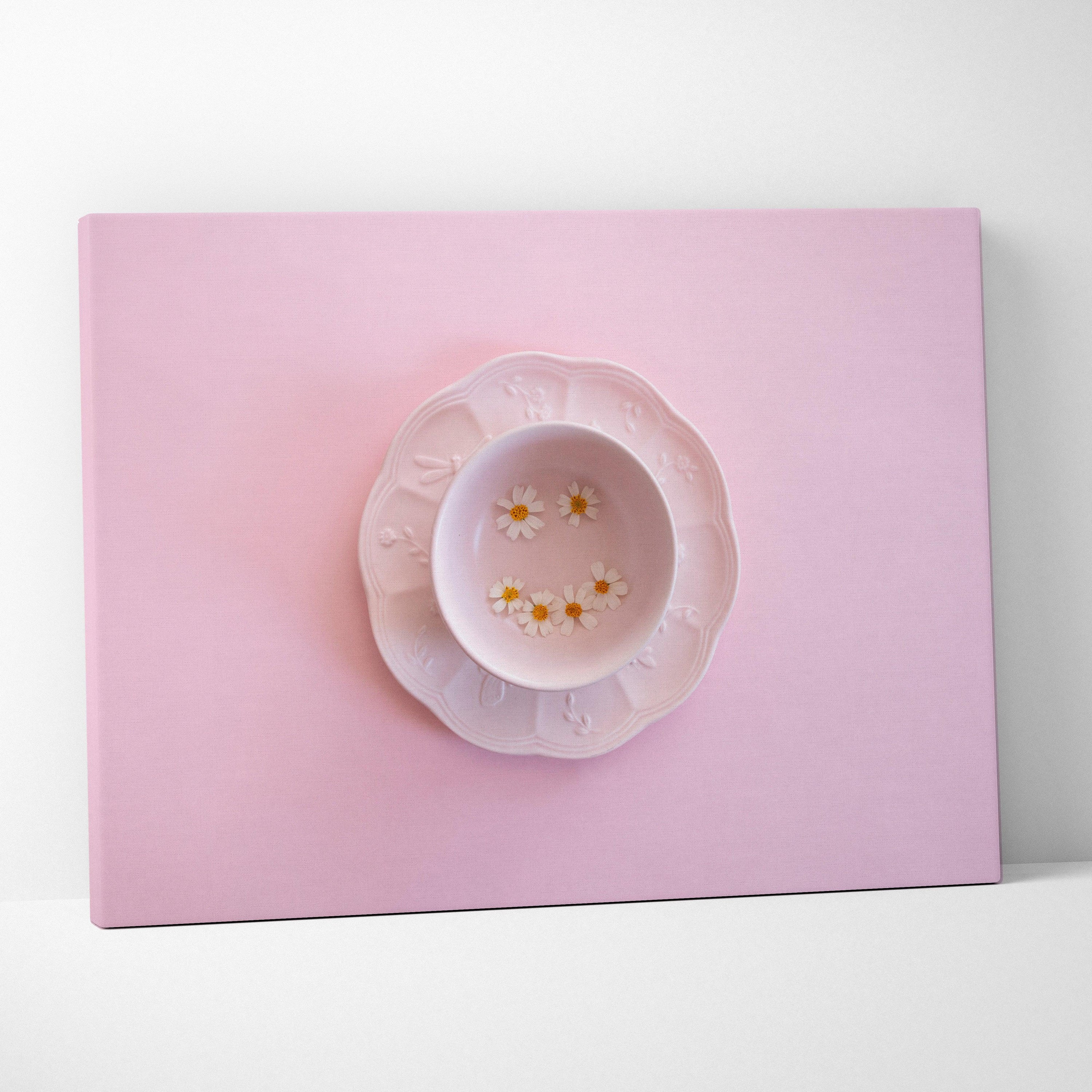 Minimalist pink canvas wall art featuring a plate with flowers, modern home decor piece.