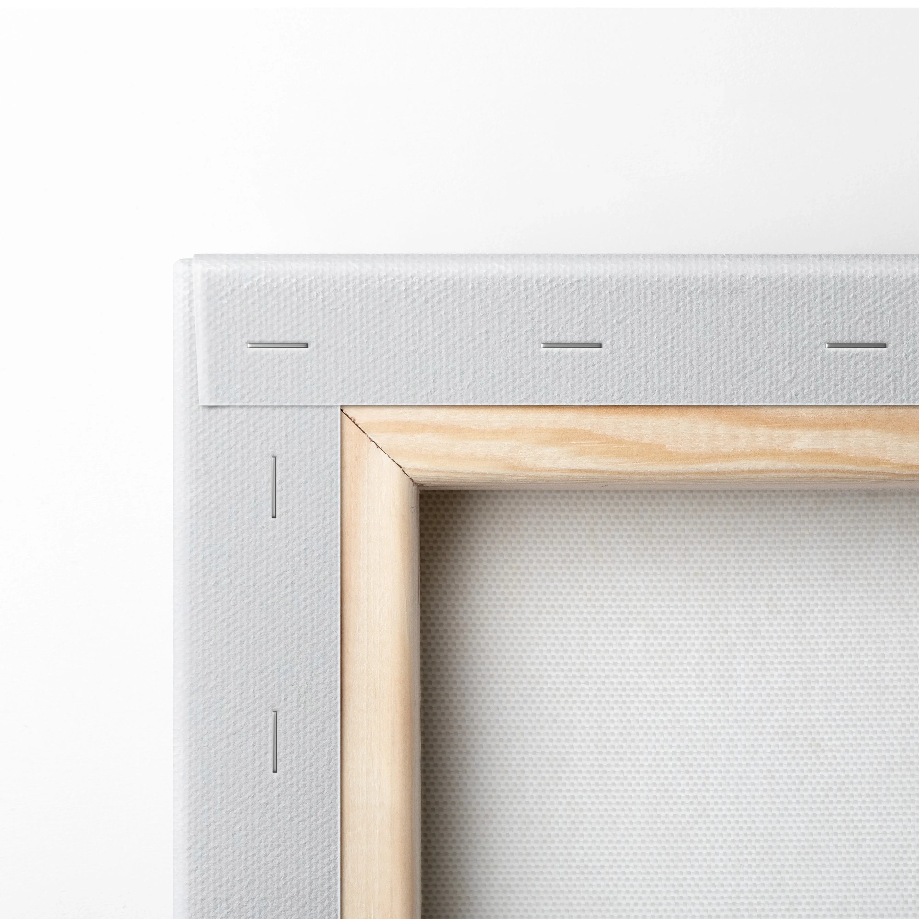 Close-up of wooden frame and white canvas texture for minimalist wall art decor.