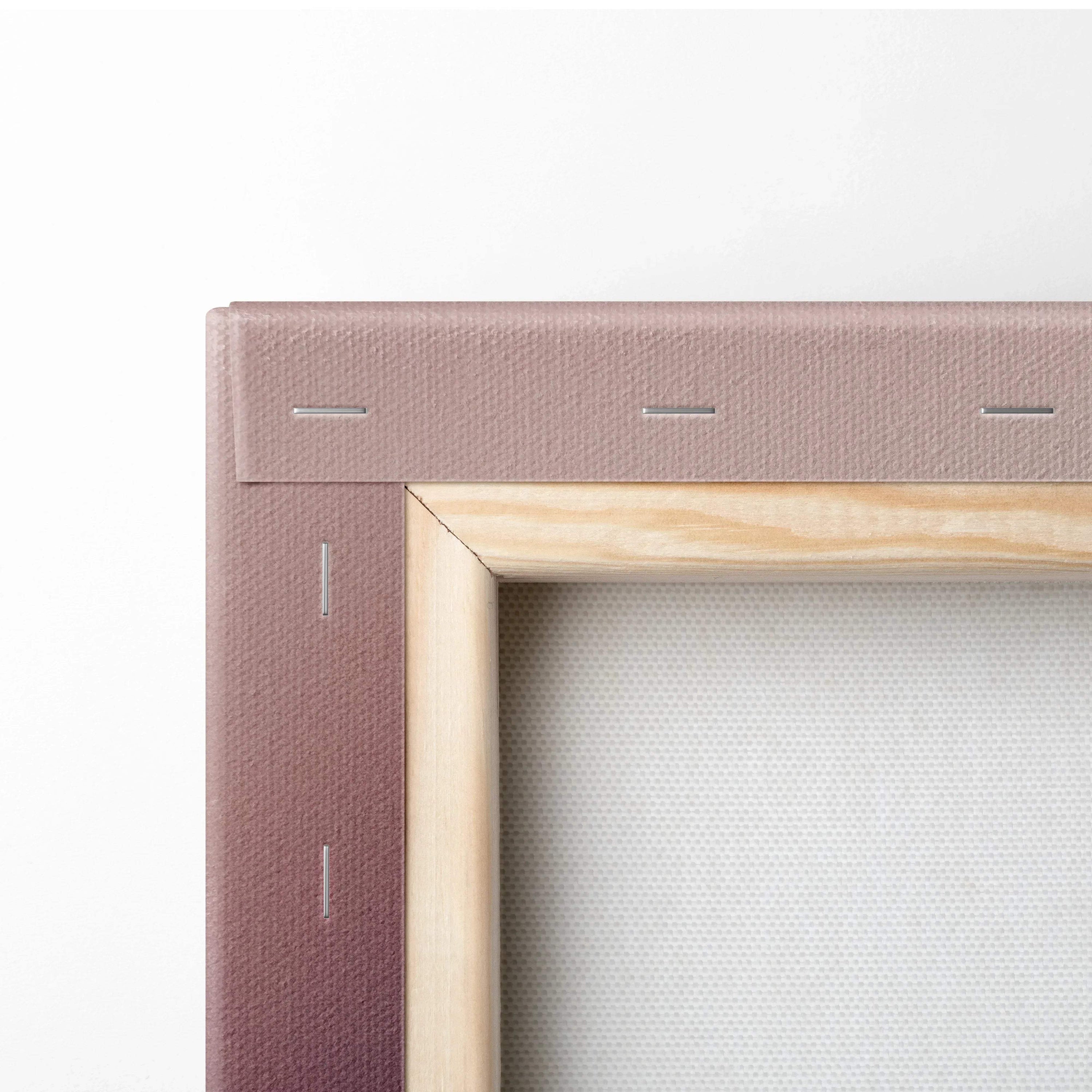 Close-up of wooden frame and stretched canvas with muted orange fabric wrapping on the back for wall art decor.