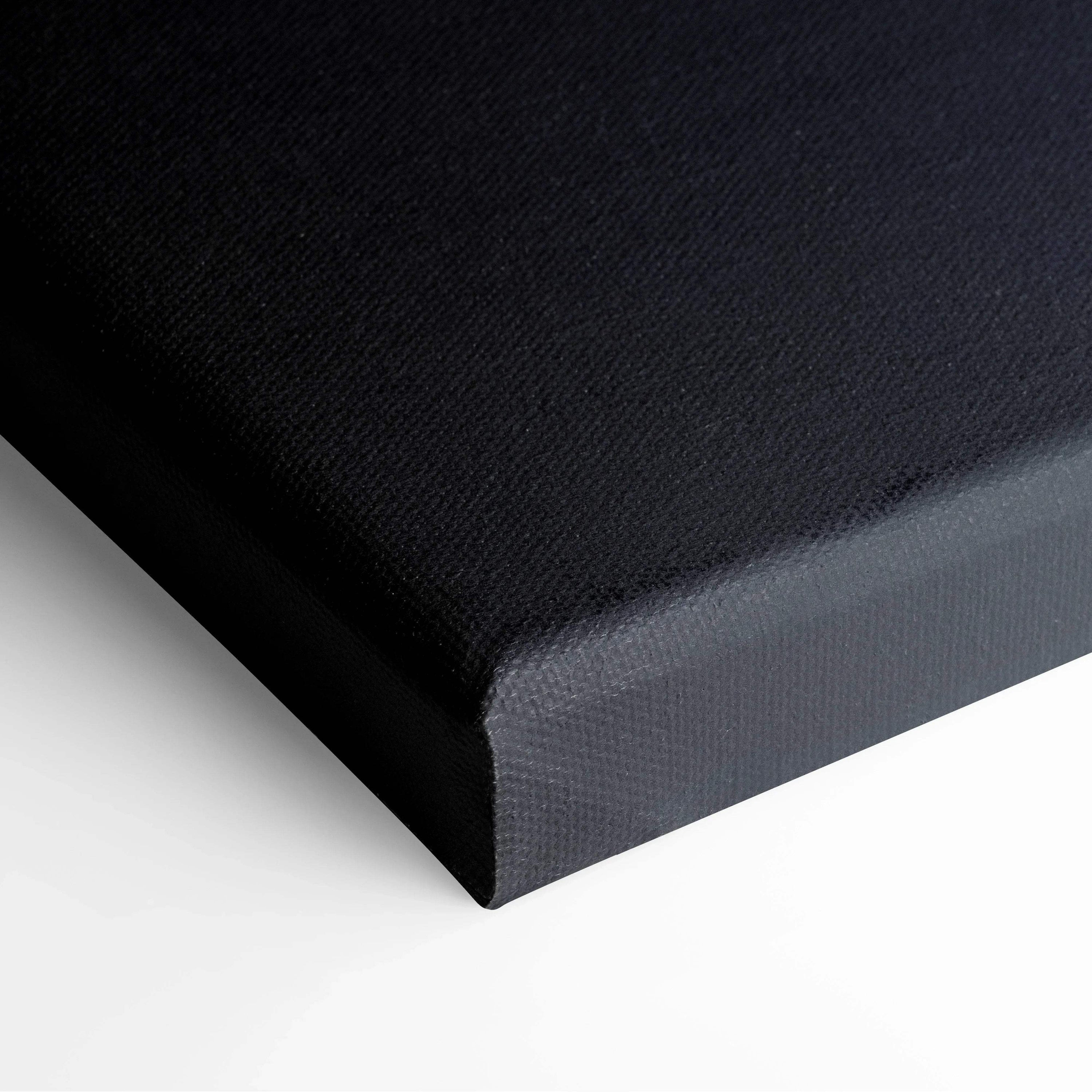 Close-up of stretched black canvas with textured fabric and wrapped edges for wall art decor.