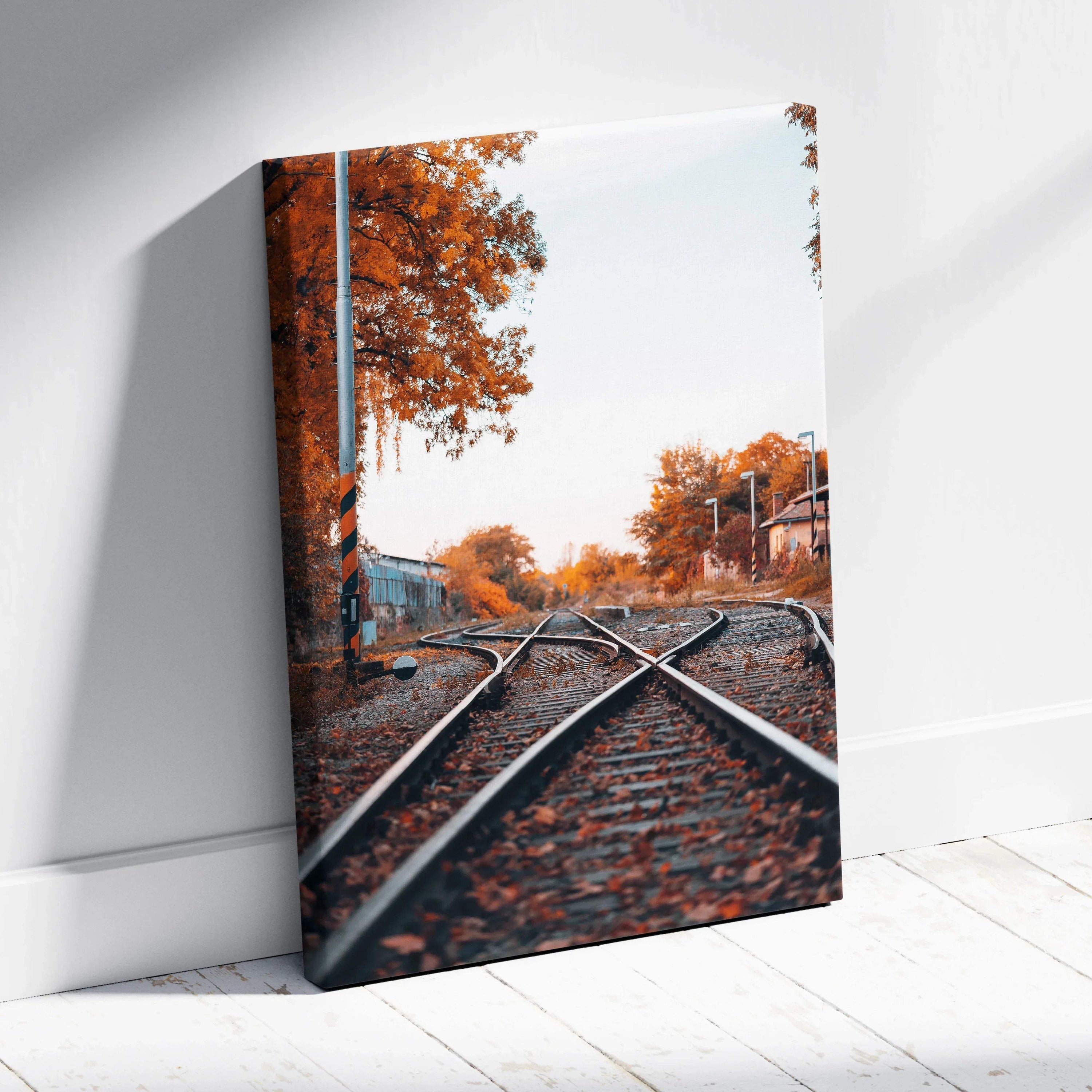 Autumn railway tracks with vibrant orange trees on vertical canvas wall art print.