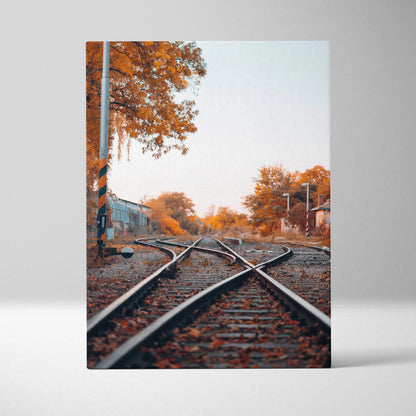 Vertical canvas wall art featuring autumn trees and railroad tracks with warm orange foliage.