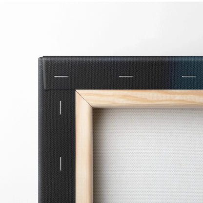 Close-up of stretched canvas corner with light natural wood frame and black fabric backing secured by staples.
