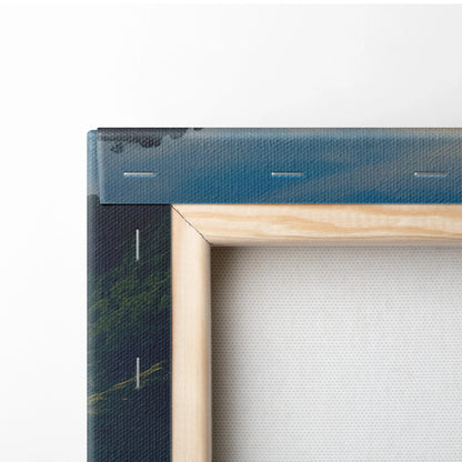 Close-up of wood-framed canvas wall art with forest and mountain landscape decor.