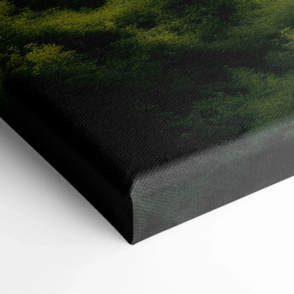 Close-up of canvas wall art corner showing dark green forest landscape with textured surface and black edges for decor.