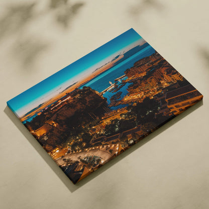 Canvas wall art print featuring a nighttime cityscape with illuminated buildings and a dark blue sky.