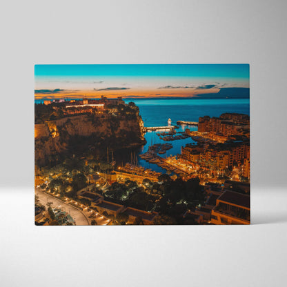 Canvas wall art print featuring a vibrant coastal cityscape at sunset with illuminated buildings and a calm sea.