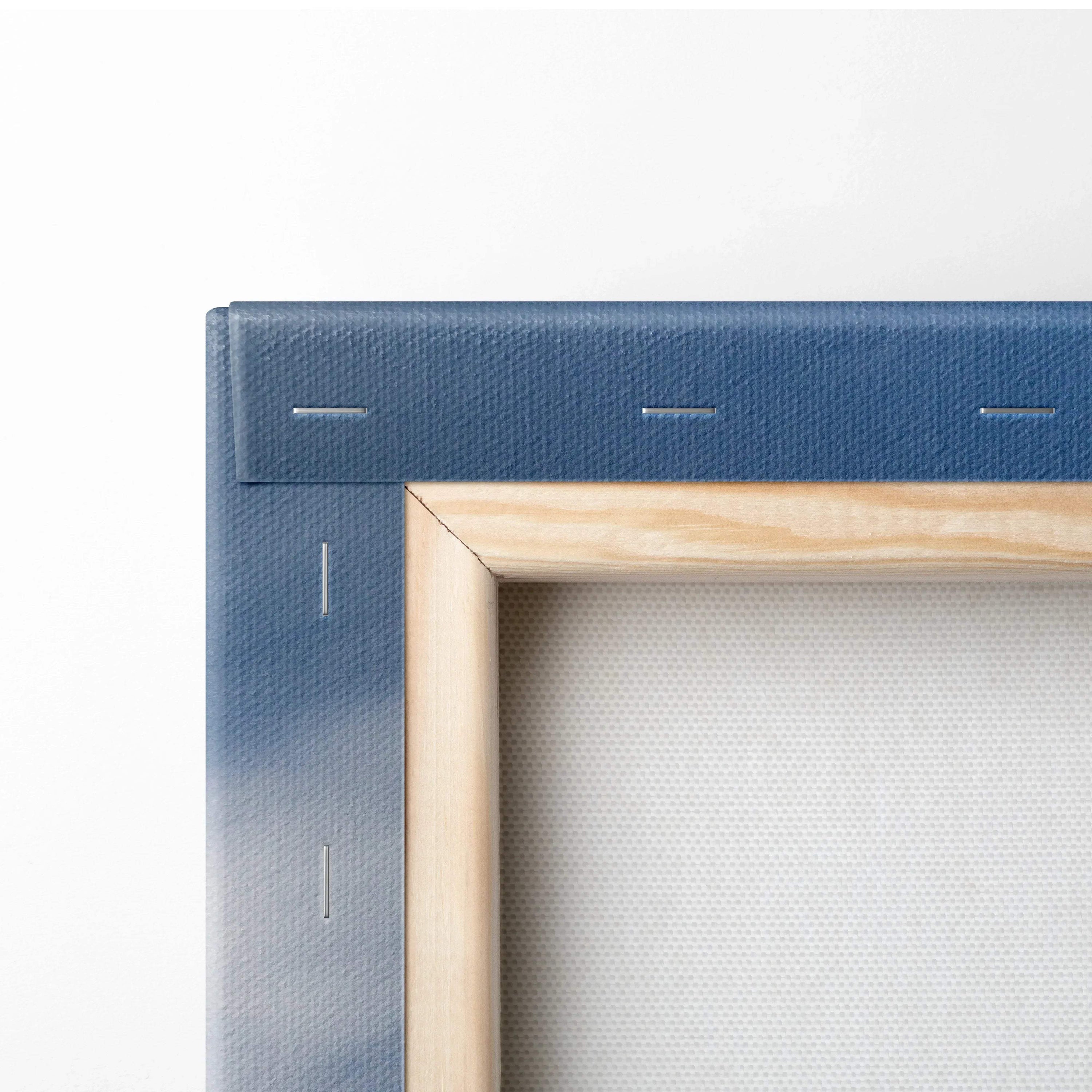 Close-up of stretched canvas with blue fabric wrapped around wooden frame, visible staples securing fabric.