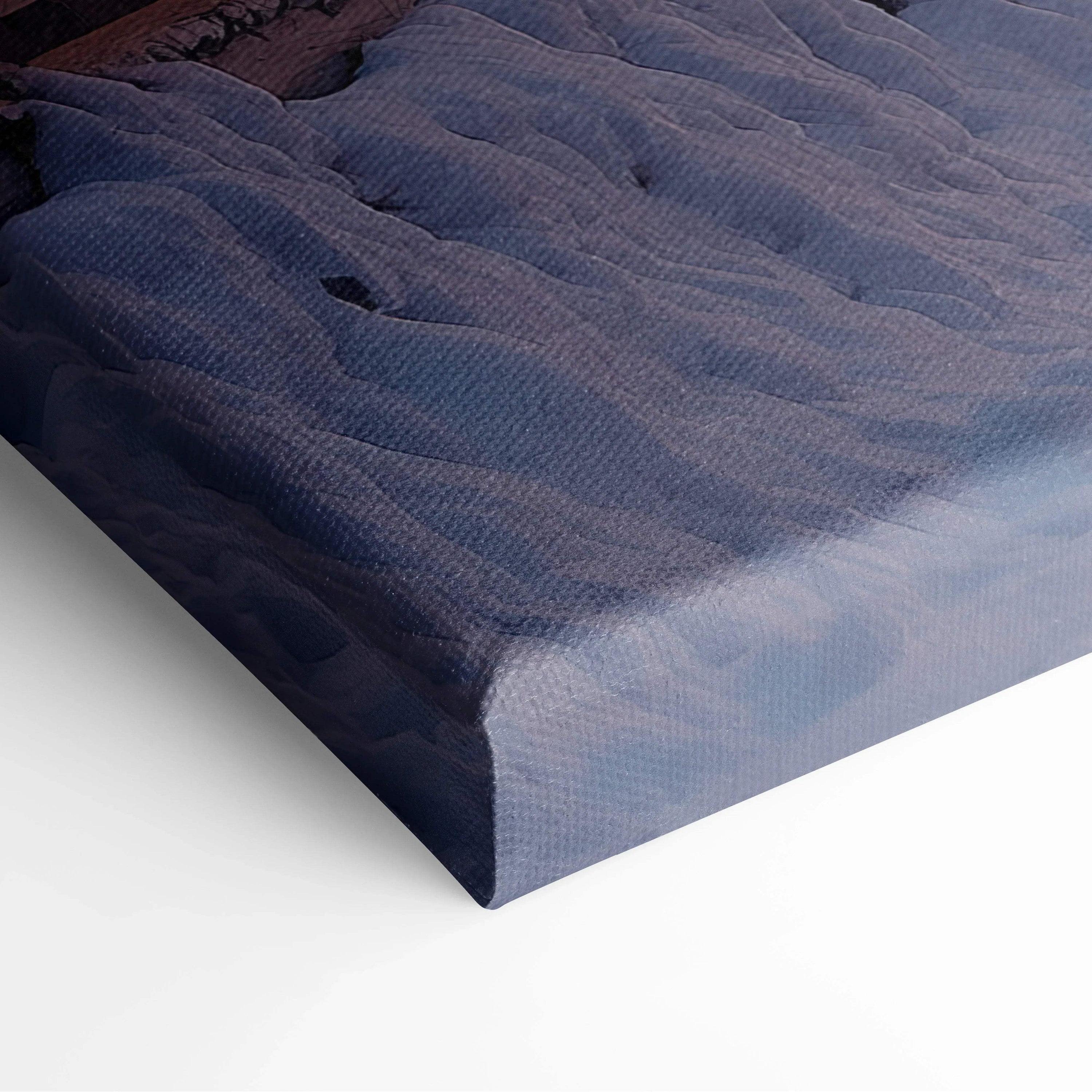 Close-up of snowy winter village digital canvas wall art with textured fabric and vibrant colors.