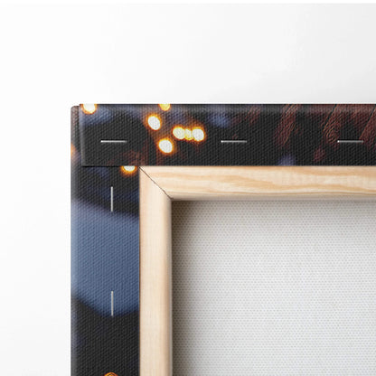 Close-up of wooden frame corner with canvas stretched and stapled, featuring dark-toned digital art print with warm light.