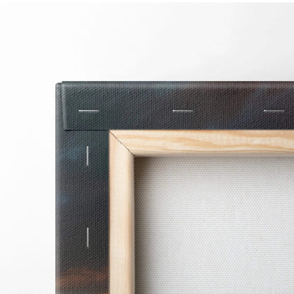 Close-up of wooden frame and stretched canvas corner with visible staples on tropical sunset wall art print.