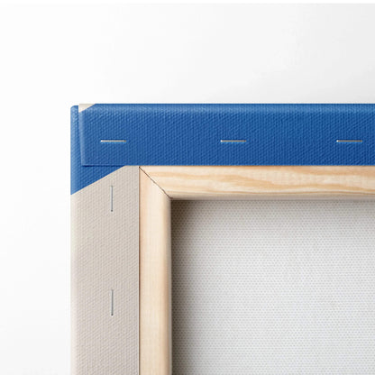 Corner close-up of blue stretched canvas wall art with wooden frame and visible staples.
