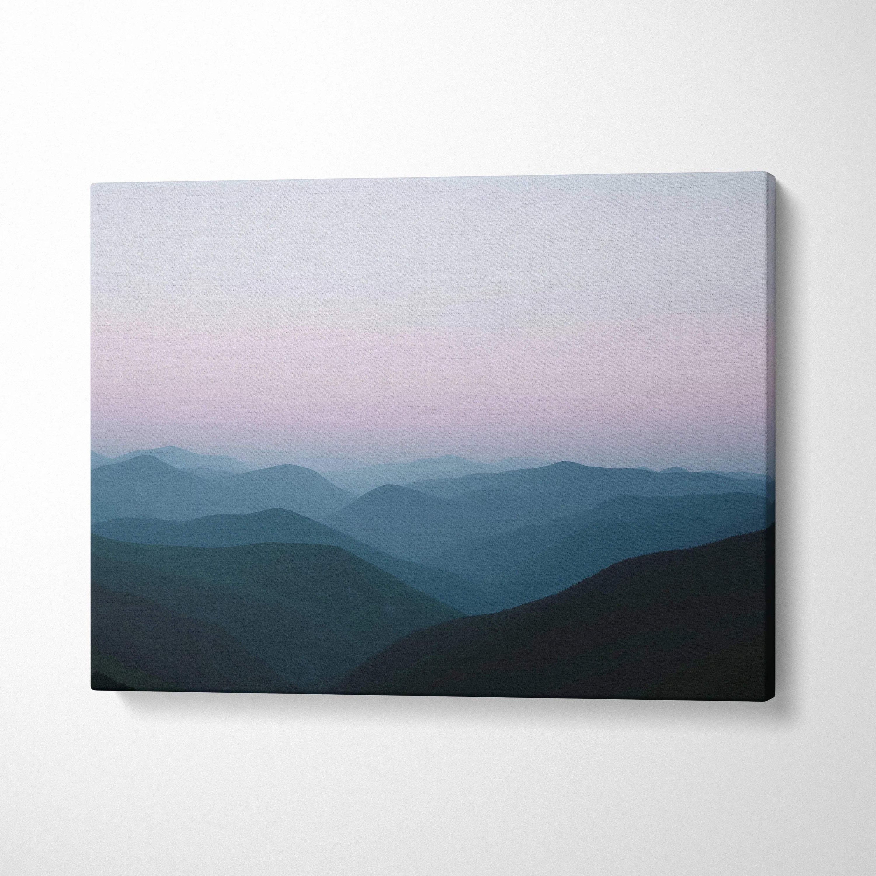 Canvas print of foggy mountain landscape in soft pink blue gradient on white wall