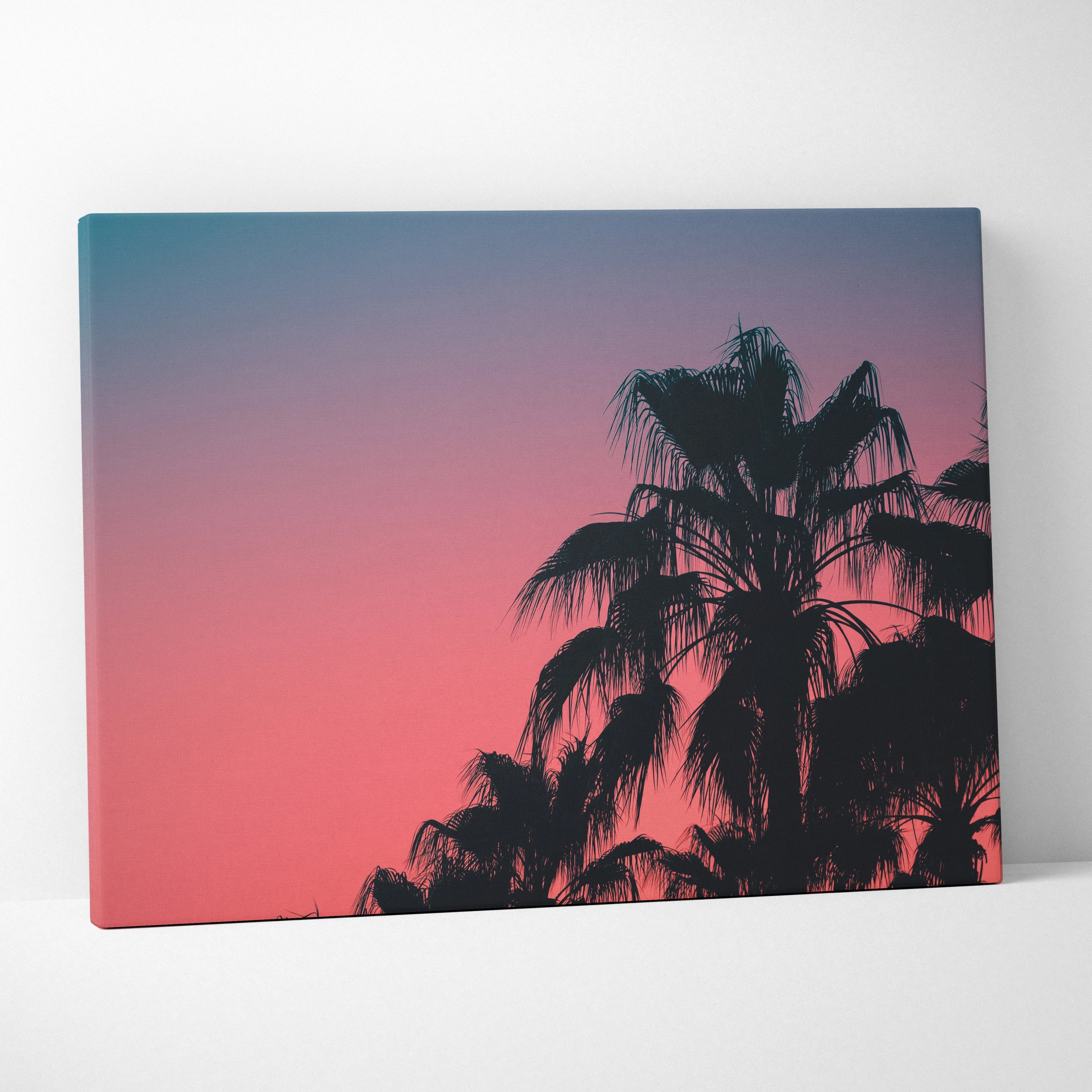 Canvas wall art featuring black palm tree silhouettes against a gradient dusk sky in pink and blue tones.