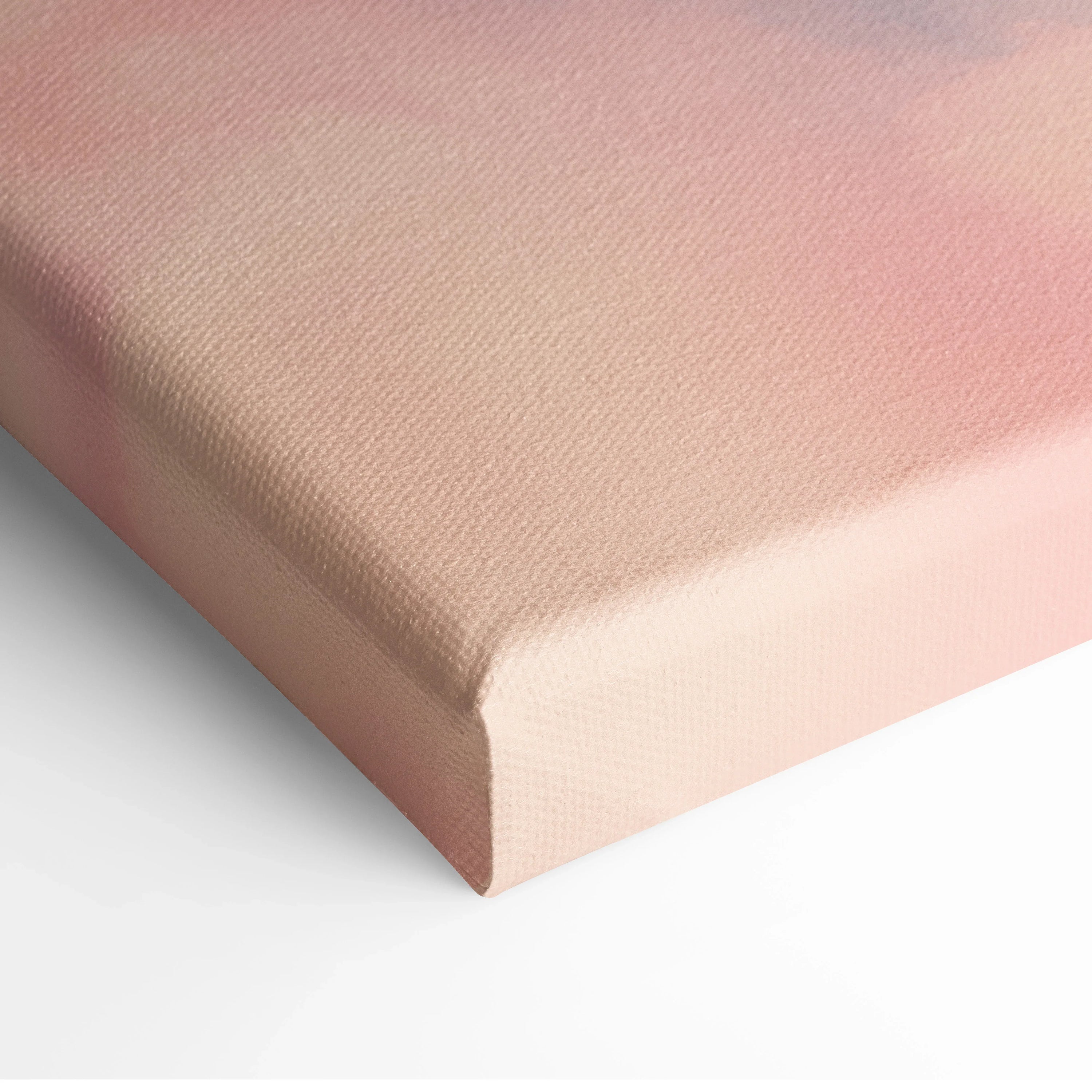 Close-up of canvas wall art with soft pink and beige gradient, textured minimalist surface.