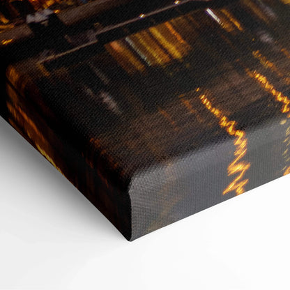 Dark-toned canvas wall art print with abstract golden light streaks and texture on the surface.