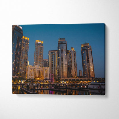 City skyline at dusk with illuminated high-rise buildings on canvas wall art print.