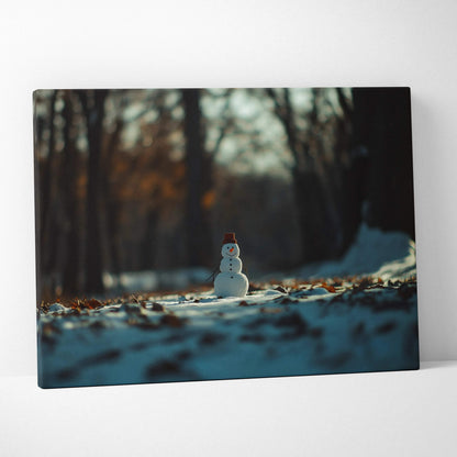 Canvas wall art featuring a small snowman in a snowy forest with dark, blurred trees in the background.
