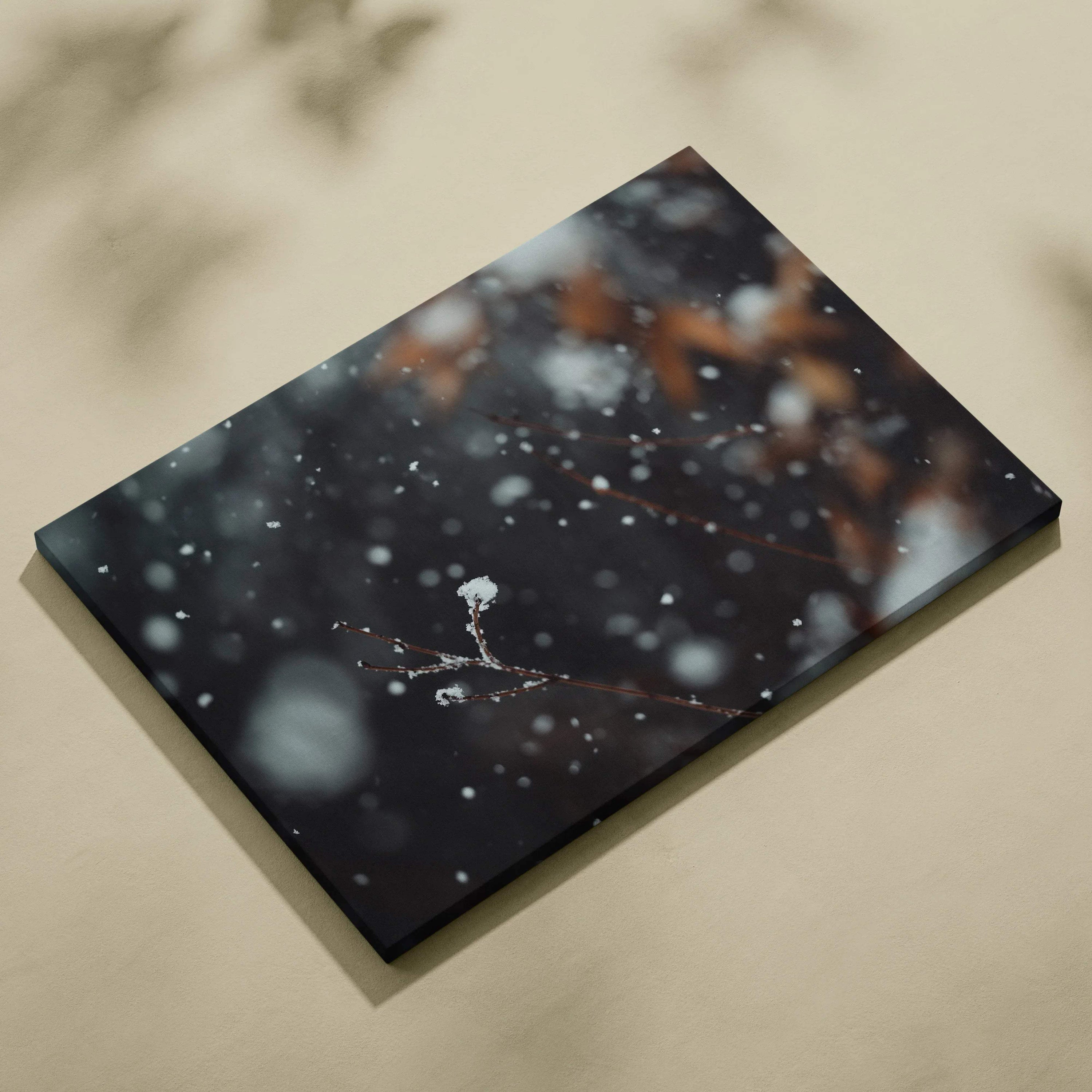 Canvas wall art featuring a dark, snowy winter scene with delicate snowflakes and blurred natural elements.