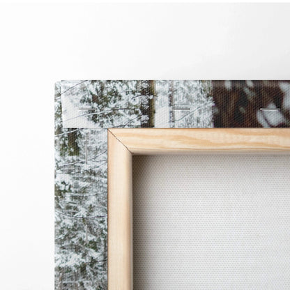 Close-up of wooden frame corner with snowy forest print on textured canvas wall art decor.