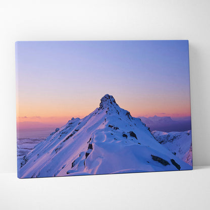 Canvas wall art featuring a snowy mountain peak at sunset with soft purple and orange sky hues.