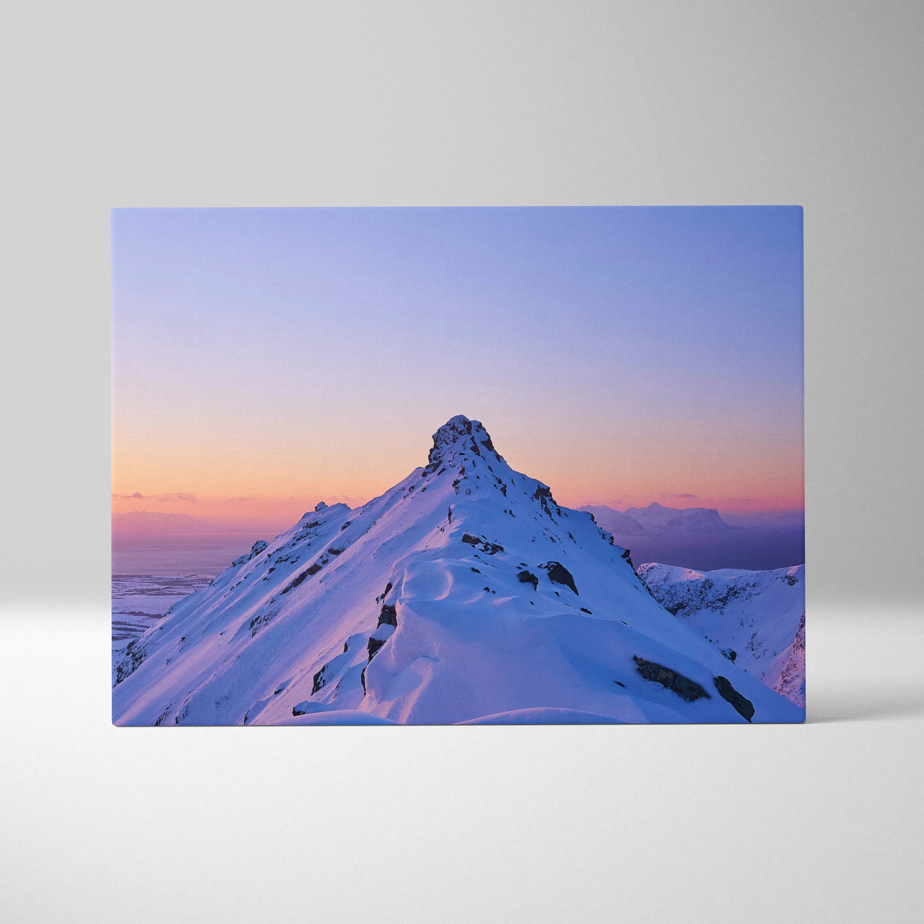 Canvas wall art featuring a snowy mountain peak at sunset with soft pink and purple skies.
