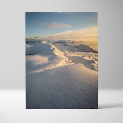 Vertical canvas wall art of snowy mountains in Norway with soft golden sunlight, winter decor.