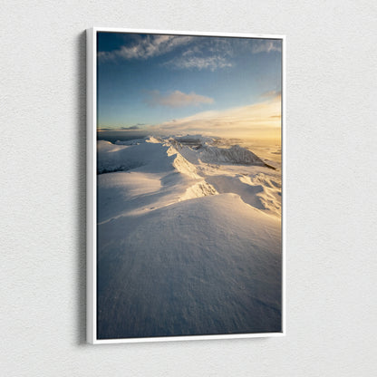 Canvas wall art featuring snow-covered Norwegian mountains under a blue sky with soft golden sunlight.