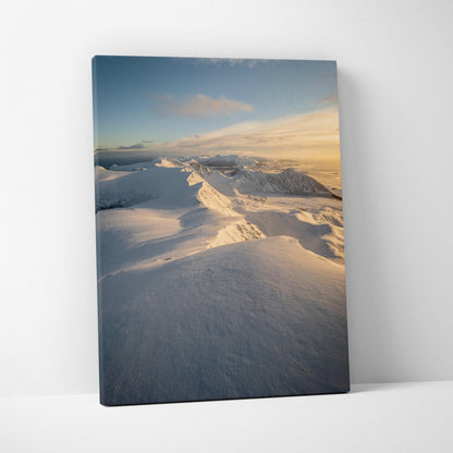 Canvas wall art featuring snowy mountain peaks bathed in golden sunlight against a soft blue sky.