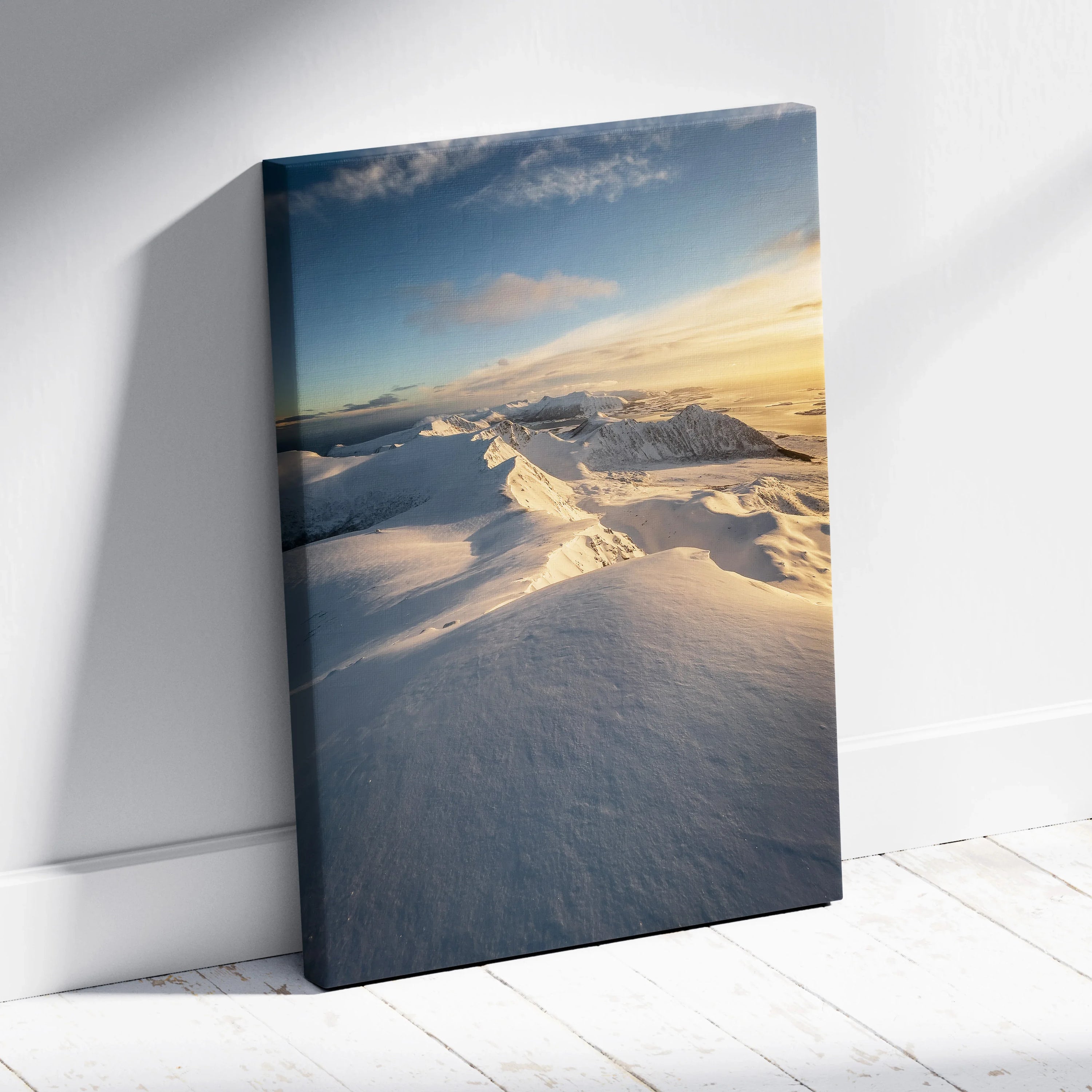 Canvas wall art featuring majestic snowy mountains under a soft sunset sky with warm light and deep shadows.