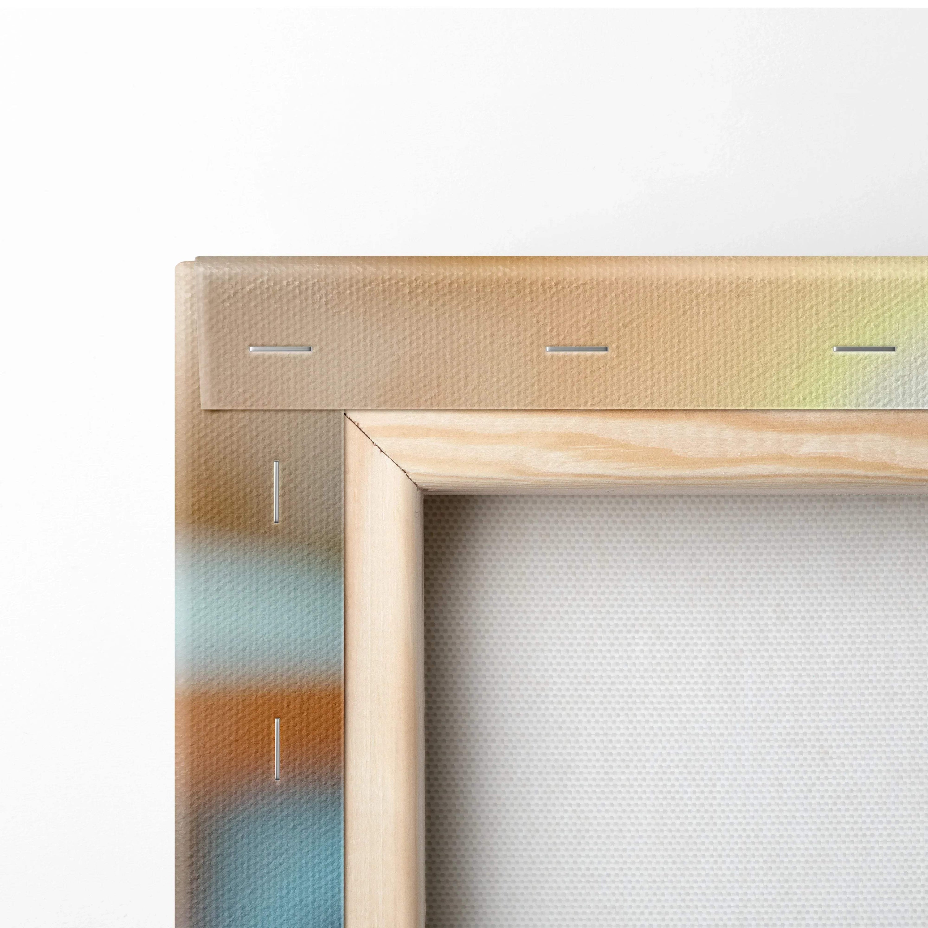 Close-up of wooden frame edge and stapled canvas backing showing texture and stretch of wall art canvas.