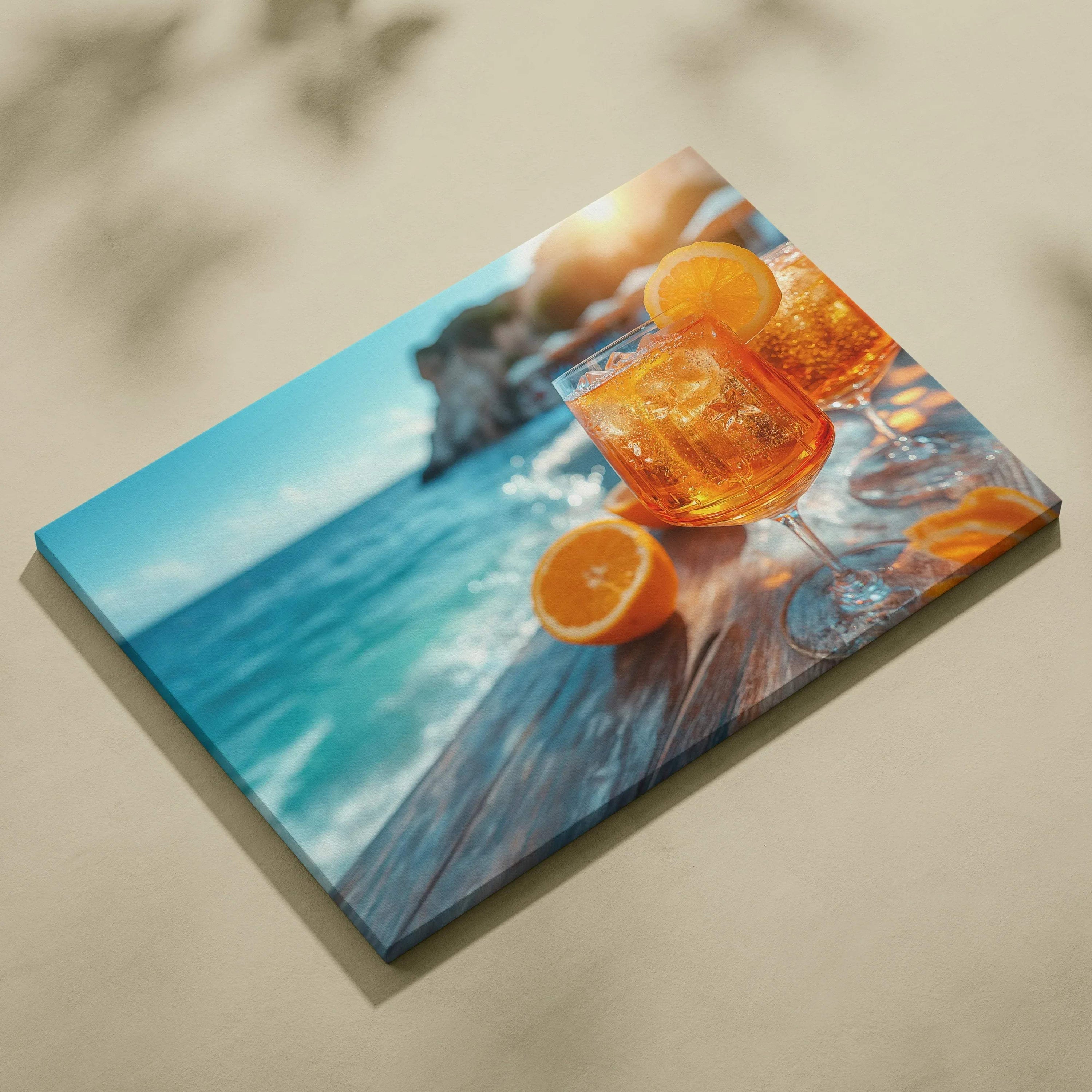 Vibrant canvas wall art showing an orange Aperol cocktail with fresh orange slices on a wooden table by the blue sea.