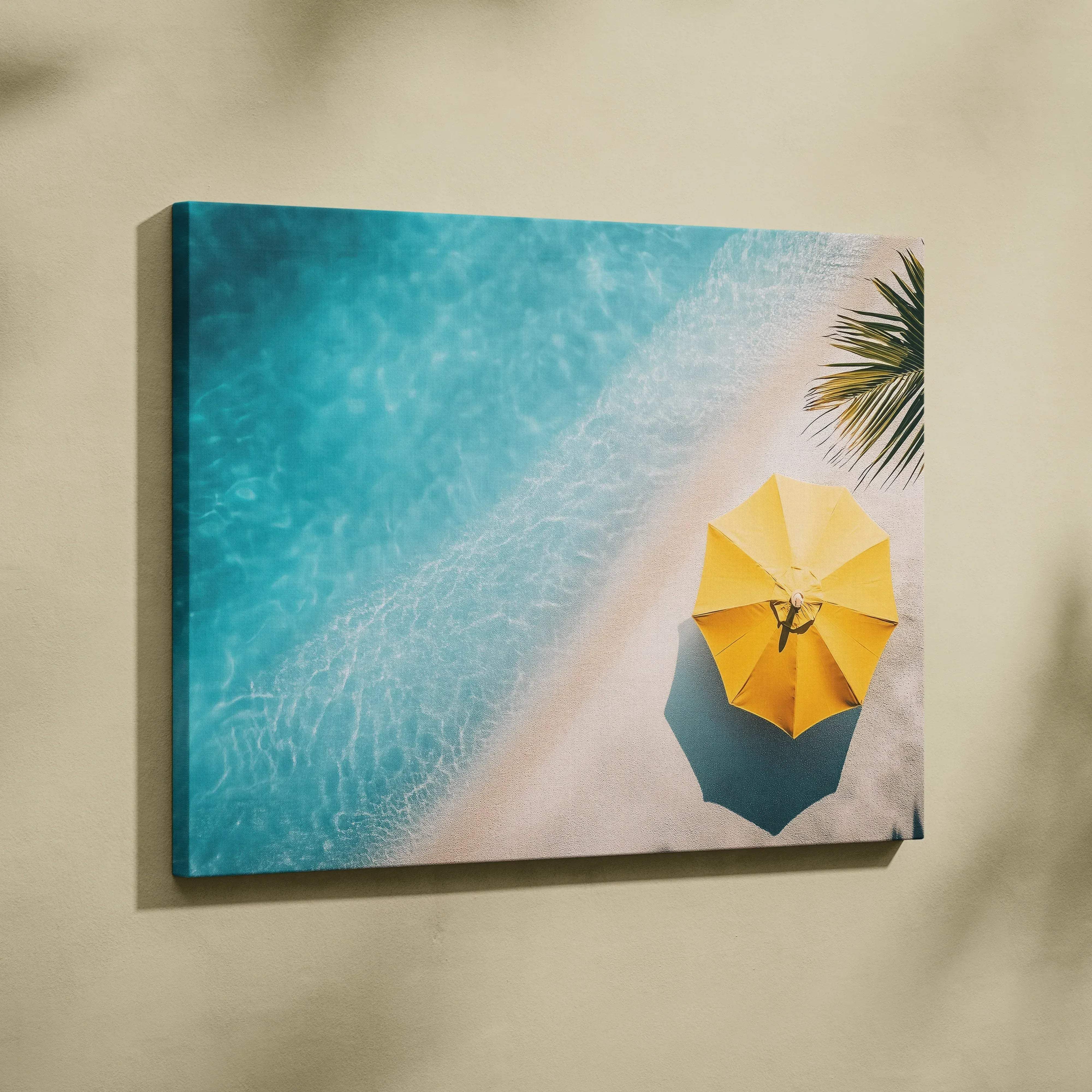 Aerial view of yellow umbrella on sandy beach by turquoise ocean waves