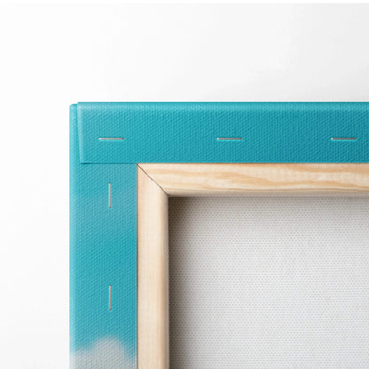 Close-up of teal-framed canvas wall art with wooden stretcher bar and stretched white fabric decor.