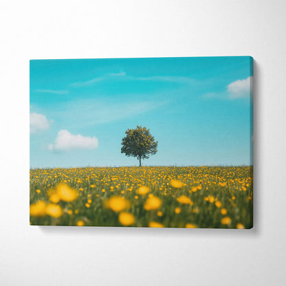 Canvas wall art featuring a solitary tree in a blooming yellow floral meadow under a bright blue sky.