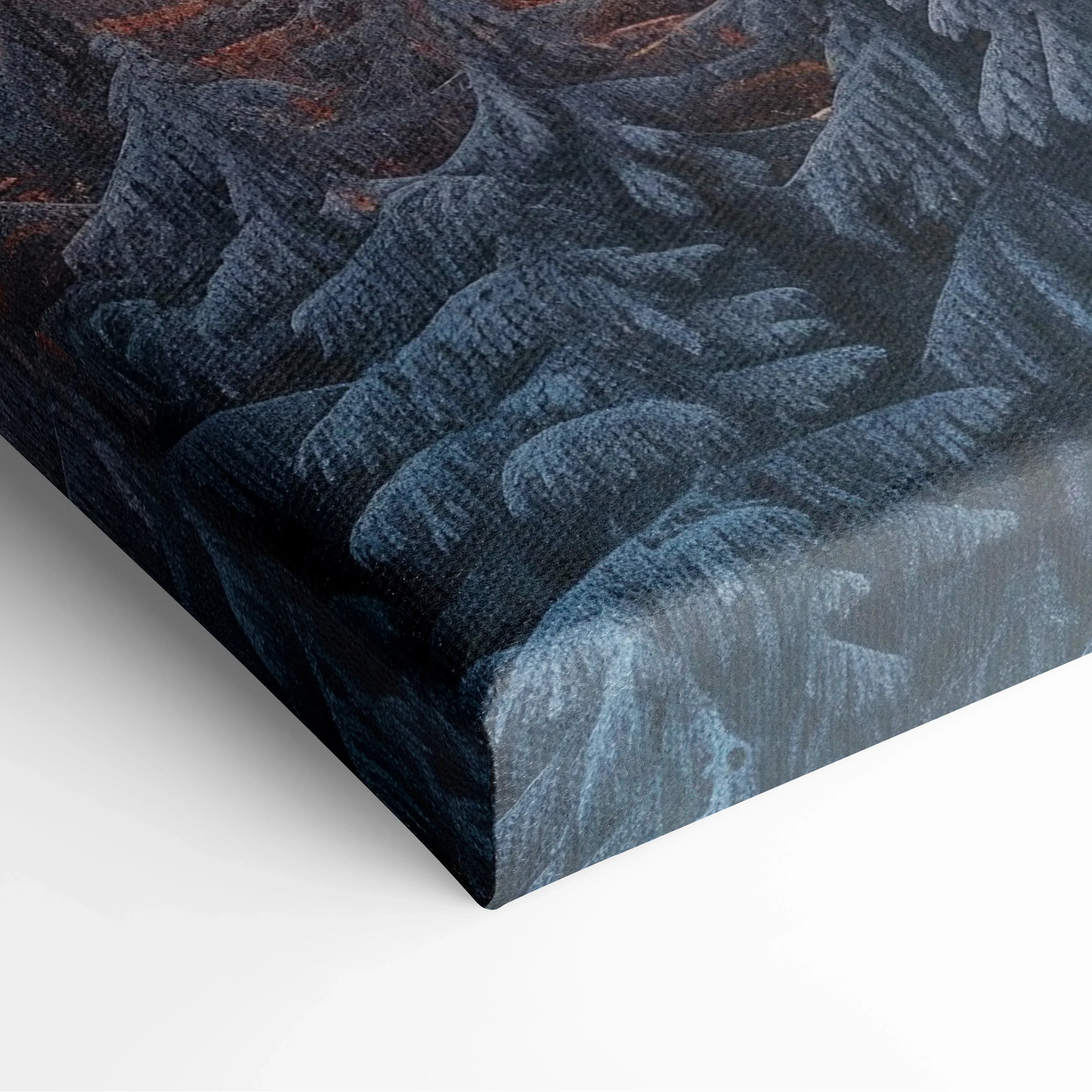 Canvas wall art featuring a high-resolution snowy mountain range at sunset with deep blue and orange hues.