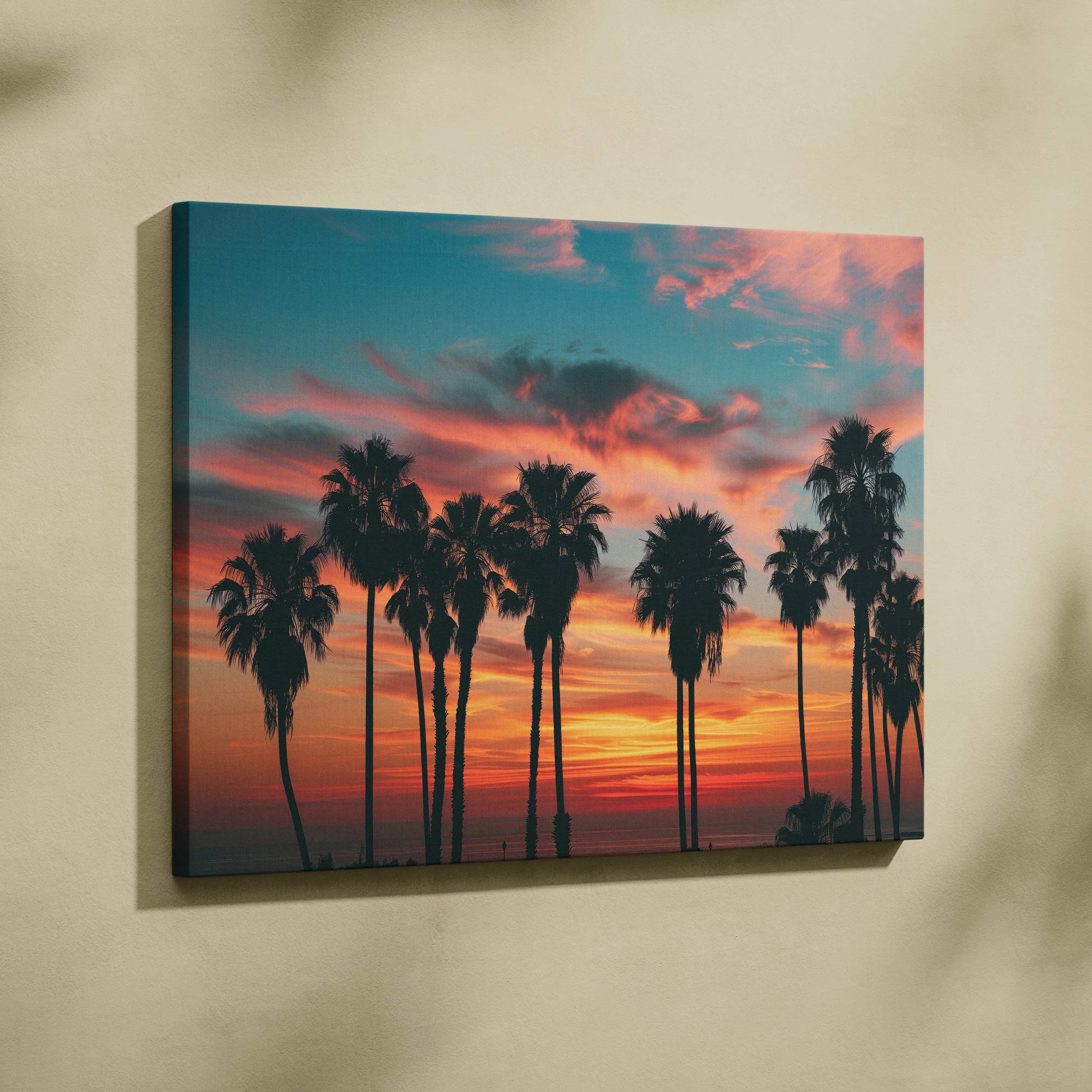 A vibrant tropical sunset palm trees silhouette canvas wall art with orange pink sunset and teal sky for home decor