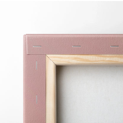 Close-up of pink canvas stretched on wooden frame with staples, wall art decor detail.