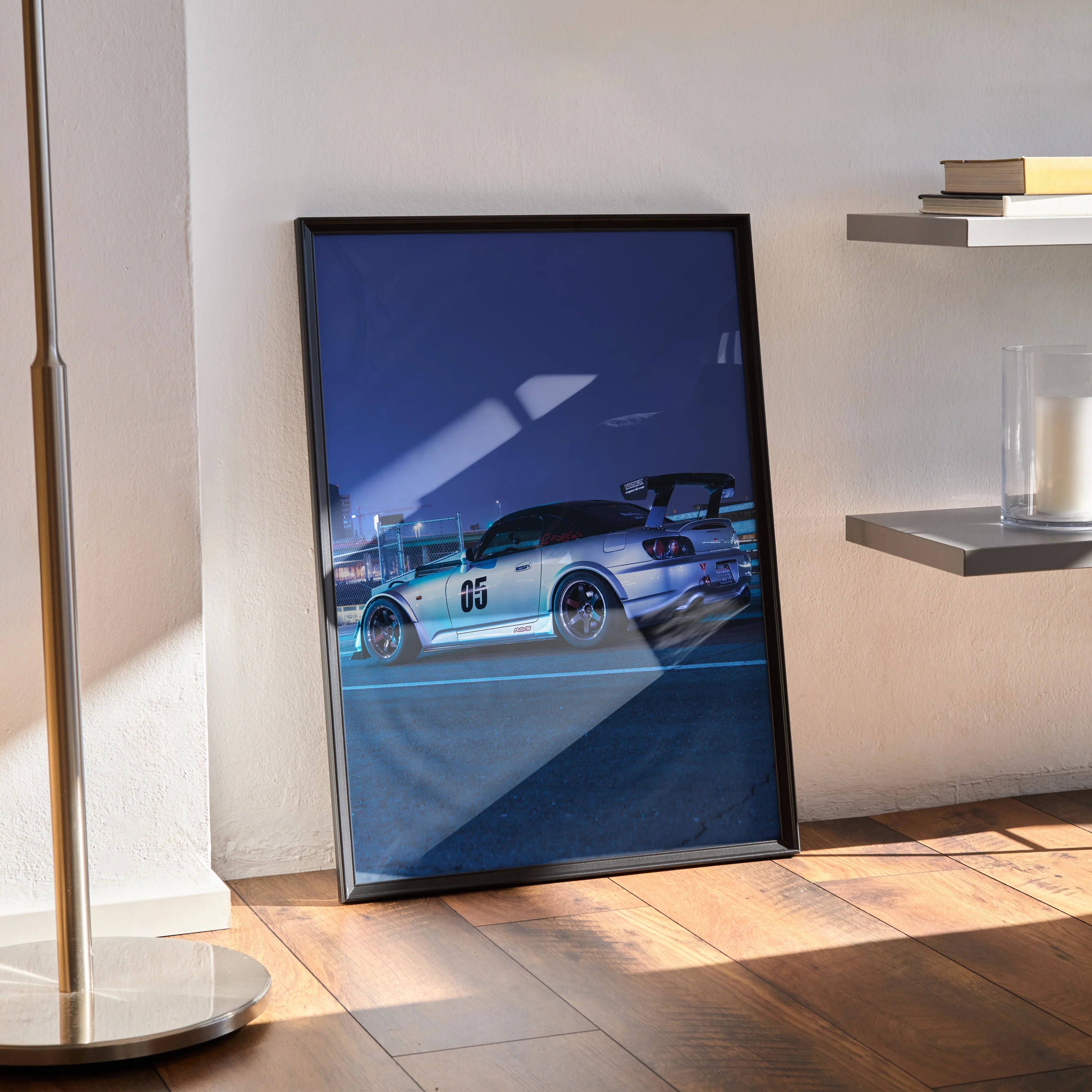 Honda S2000 silver sports car poster in black frame leaning against wall as modern wall art.