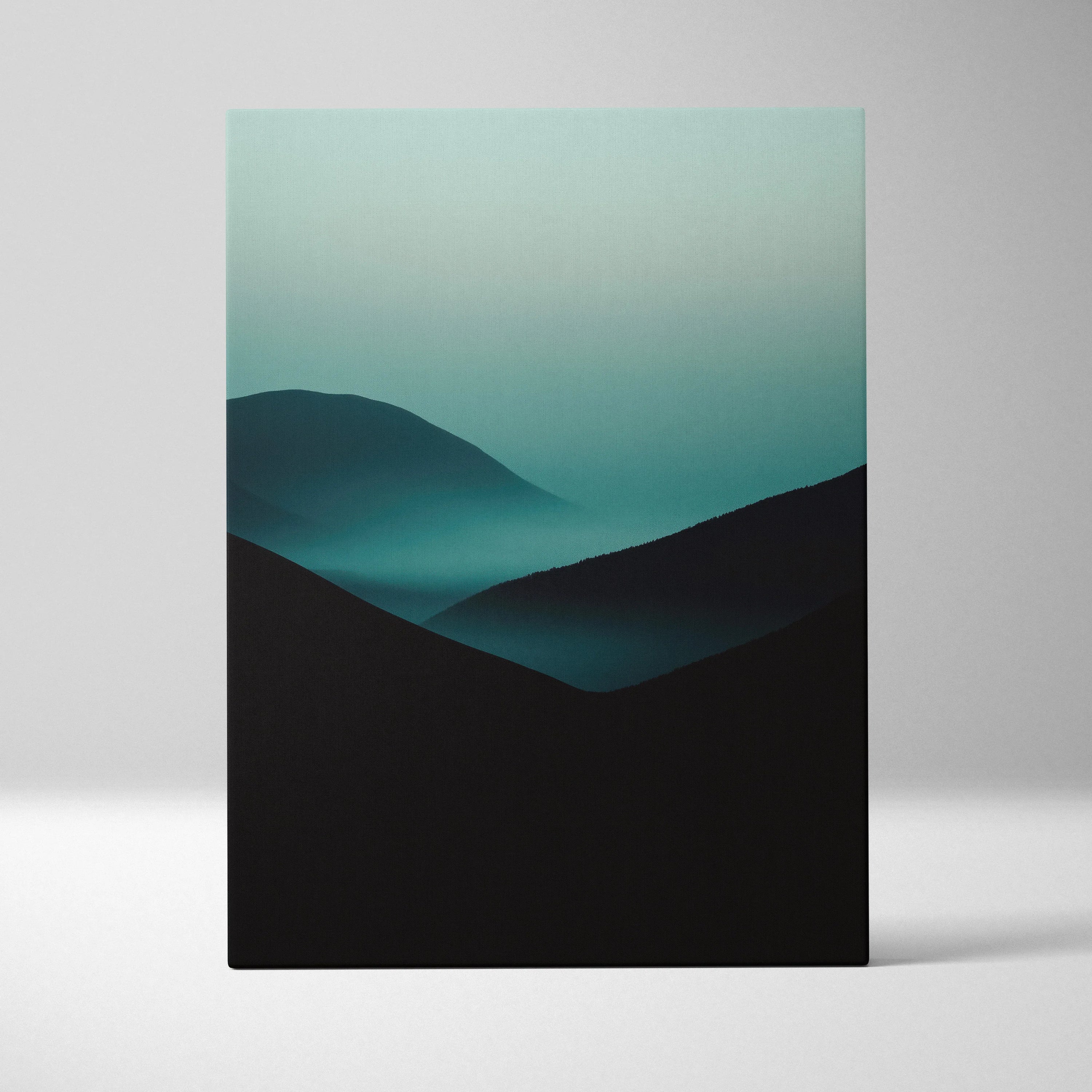 Minimalist canvas wall art featuring dark mountain silhouettes layered with soft blue-green fog.