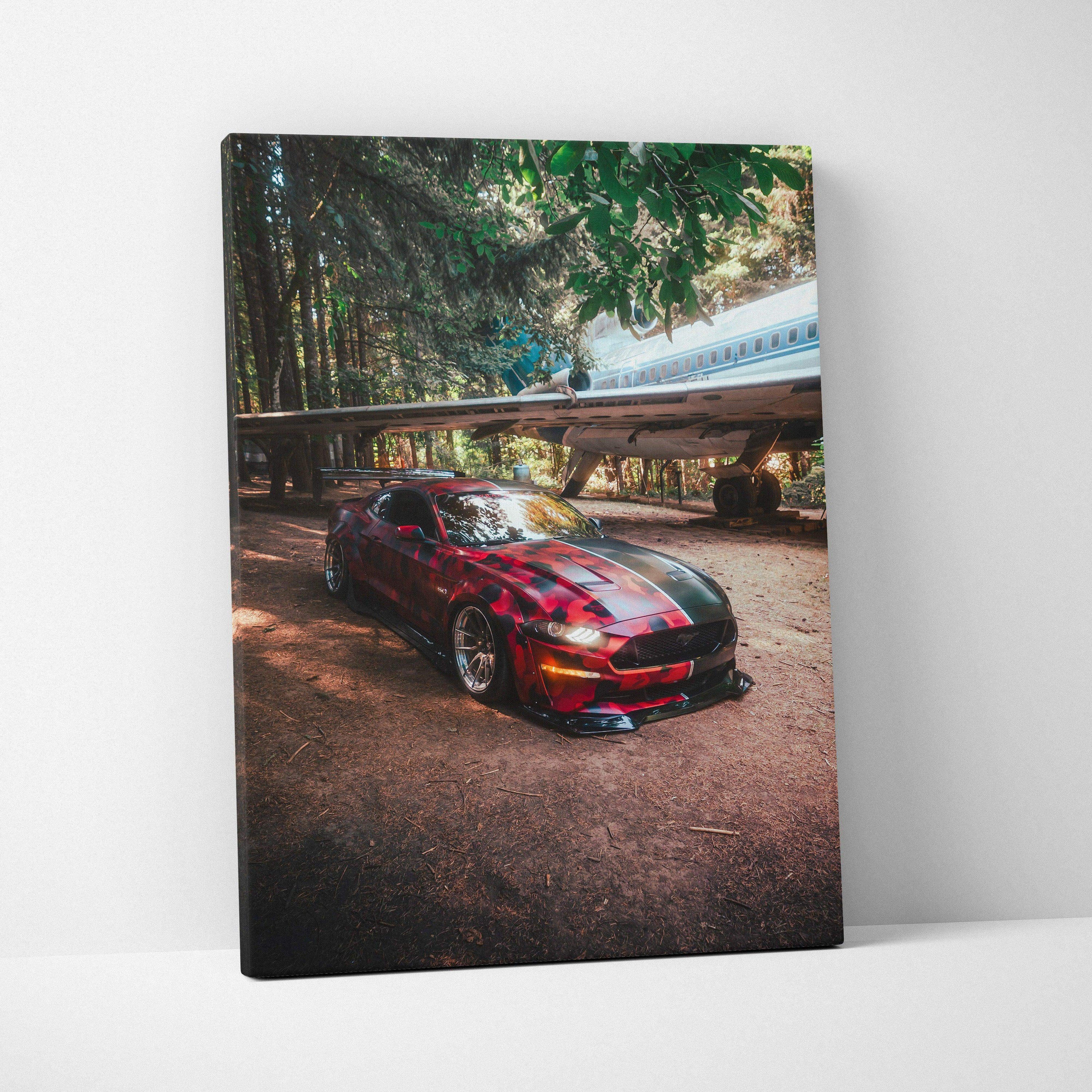 Red Ford Mustang S550 parked under trees and a train bridge, vertical canvas art wall decor.