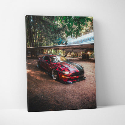 Red Ford Mustang S550 parked under trees and a train bridge, vertical canvas art wall decor.